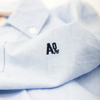AO76 Blue axel shirt logo.
